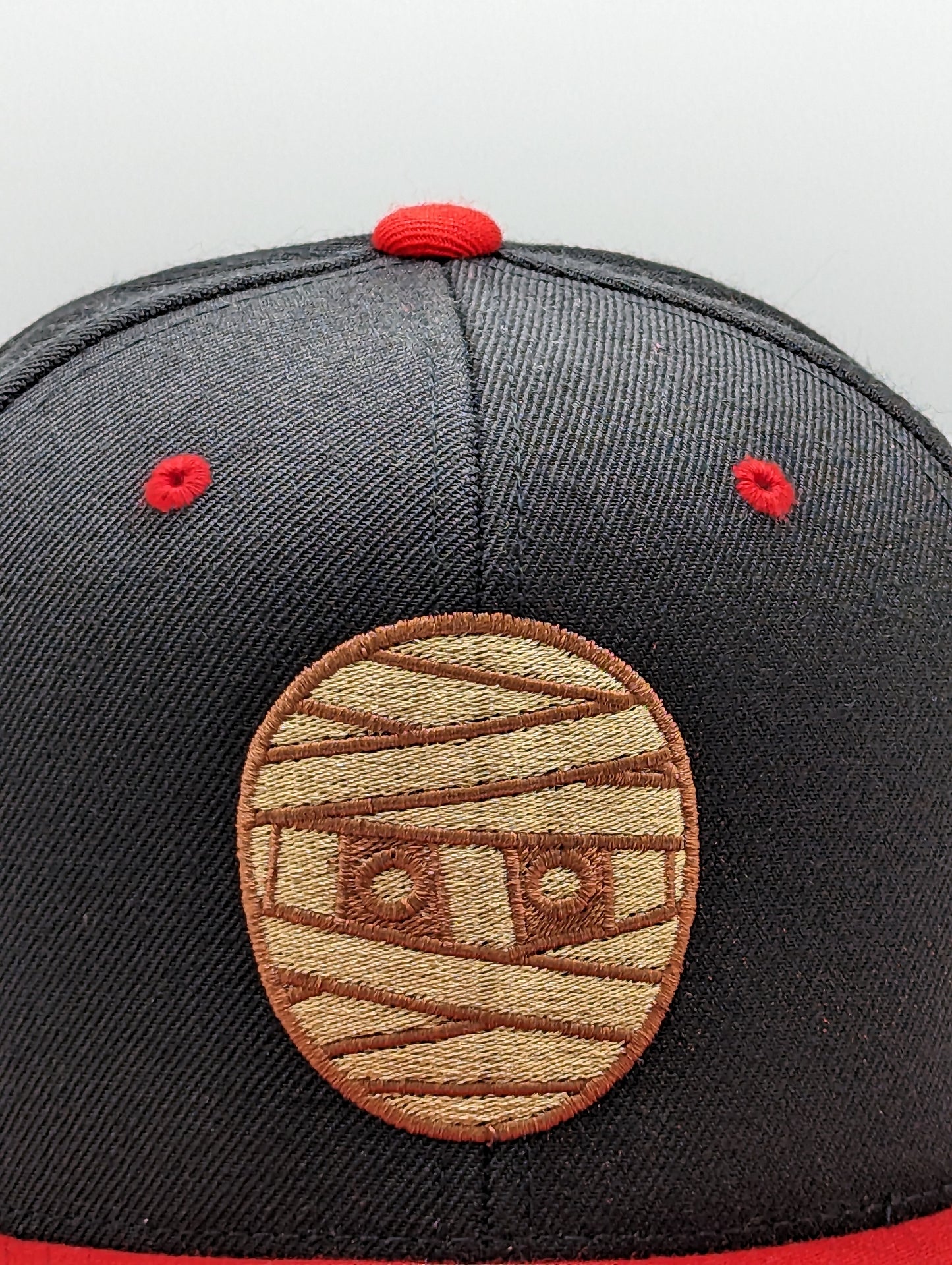 SNAPBACK CON CABEZA DE GOMA NEGRO / ROJO